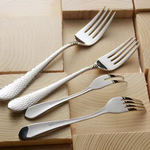 Elegant 304 stainless steel fork set with hammered finish on light wood background