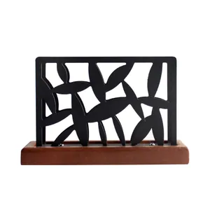 Modern black cutout stainless steel napkin holder with wooden base for restaurant table
