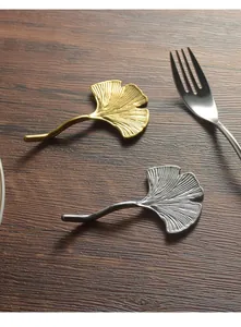 Elegant ginkgo leaf shaped stainless steel chopstick and spoon rests in gold and silver
