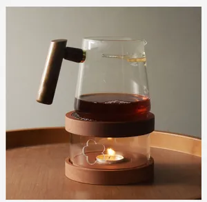 Detailed shot of walnut wood candle tea warmer base with teapot on a wooden tray