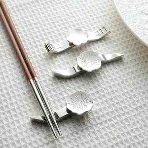 Stainless steel chopstick rest set featuring an elegant plum blossom floral design for dining