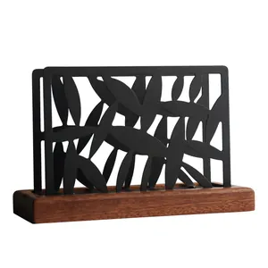 Nordic style black metal napkin holder with bamboo leaf pattern on solid wood base