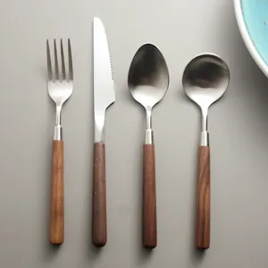 Elegant 4-piece stainless steel cutlery set featuring natural walnut wood handles for home dining