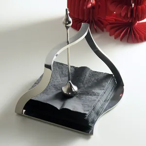 Minimalist stainless steel napkin holder with curved frame and central weighted rod
