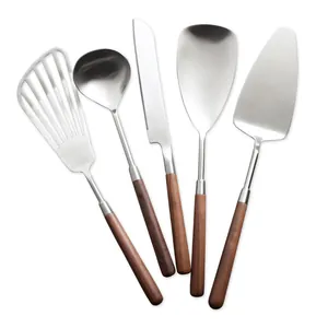 304 Stainless steel kitchen utensil set with elegant walnut wood handles on white.