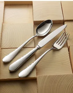 Detail view showing the hammered texture on stainless steel knife, fork and spoon handles