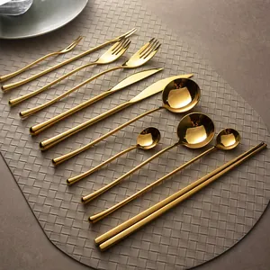 Luxurious gold mirror-polished 304 stainless steel cutlery set on woven placemat