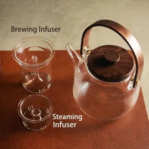 Ribbed glass teapot with wooden handle and lid featuring two types of glass infuser liners