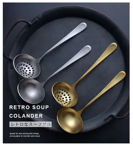 Detail view of retro 304 stainless steel gold and silver soup and colander ladles