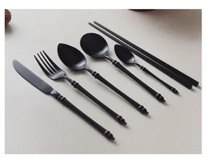 Premium matte black stainless steel cutlery set featuring elegant bamboo-inspired handles