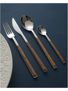 Macro detail view of Nordic stainless steel cutlery set featuring elegant wood grain handles.