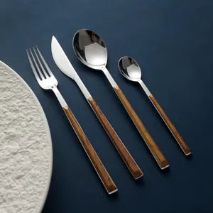 Modern 304 stainless steel cutlery set with wood grain handles on dark blue background