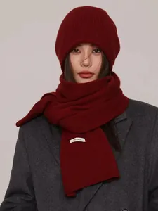 Model wearing premium 100% wool knitted burgundy scarf and matching beanie set