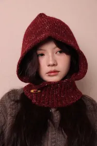 Close-up of marled knit alpaca wool balaclava with retro toggle button on model