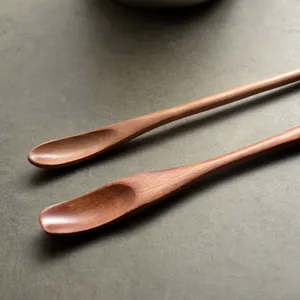 Pair of handcrafted Japanese long-handled wooden stirring spoons for honey and coffee.