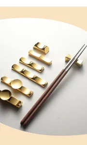 Close-up of elegant gold stainless steel chopstick rests in various modern designs