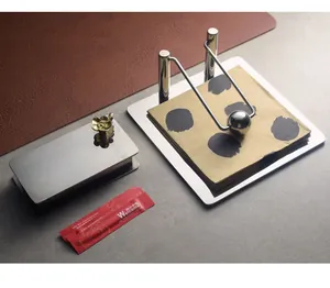 Elegant stainless steel napkin holder with weighted arm and gold flower toothpick box detail