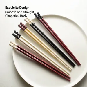High-end creative non-slip chopsticks featuring unique candy bean tops on white plate