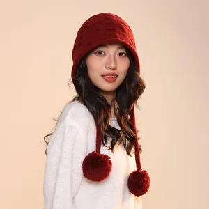Premium red all-wool elf style knitted beanie with pom-poms shown on female model