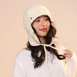 Close-up detail of a soft off-white 100% wool knitted Balaclava featuring chin ties.
