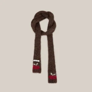 Detail of dark brown fuzzy knit scarf featuring cute red cherry pattern embroidery