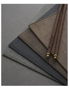 Close-up detail of textured PU leather placemats in neutral tones for dining table