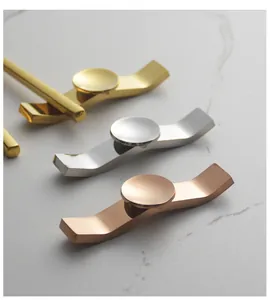 Detailed view of Ruyi-style stainless steel chopstick rests in gold, silver, and rose gold