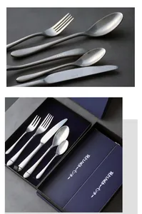 Detailed view of vintage distressed stainless steel cutlery set with logo in gift box