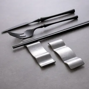 Elegant Japanese wavy stainless steel cutlery rests with matte black knife fork set.