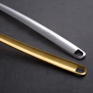 Detail of silver and gold 304 stainless steel skimmer spoon handles with hanging holes