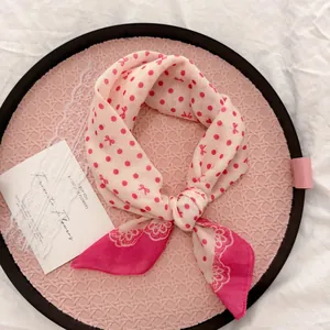 Detail of pastoral style cotton-linen scarf with pink polka dots and bow patterns