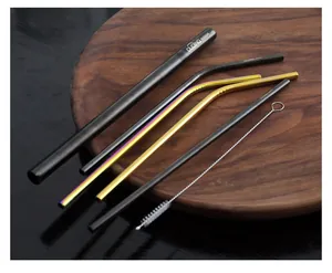 Detailed macro view of SUS304 stainless steel straw set with cleaning brush on wooden tray