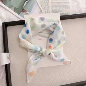 Close-up of a white cotton linen neckerchief with colorful watercolor polka dots.