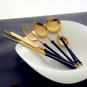 Matte black and gold stainless steel cutlery set with bamboo joint handles