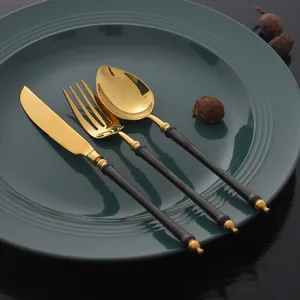Elegant black and gold 304 stainless steel cutlery set featuring knife, fork, and spoon.