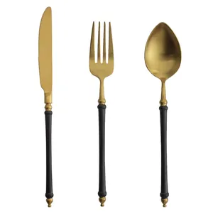 Elegant black and gold matte cutlery set featuring unique bamboo handle design for dining