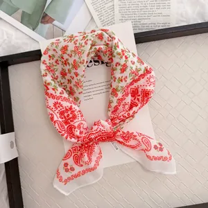 Detailed view of pastoral cotton linen square scarf with red floral and paisley patterns