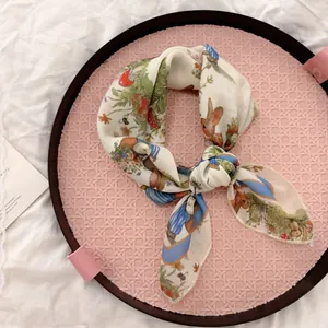 Detail view of a vintage pastoral style floral cotton linen neck scarf with rabbit pattern