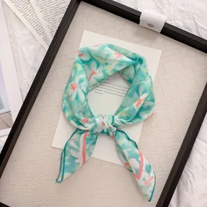 Detailed view of mint green floral cotton linen neckerchief with tie-dye pattern