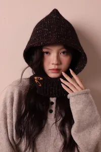 Close-up view of a chic retro knit Balaclava with toggle buttons worn by an Asian model