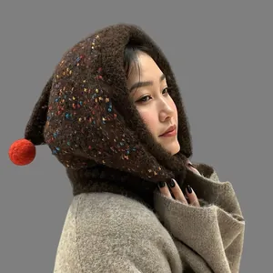 Detailed side view of winter knit balaclava hood with colorful speckles and red pompom