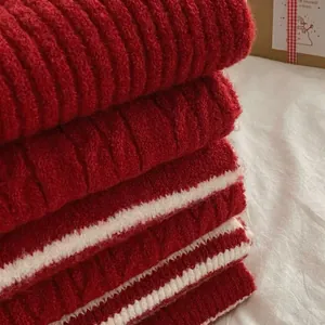 Macro detail shot showing texture of cozy red and white striped knit scarves for winter.