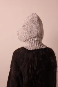 Back view of a melange knitted alpaca wool hooded balaclava scarf in beige