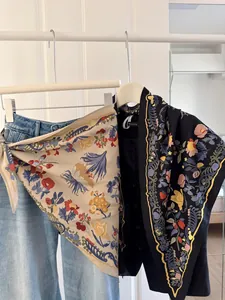 Detailed view of floral printed triangular scarves styled as a layering accessory