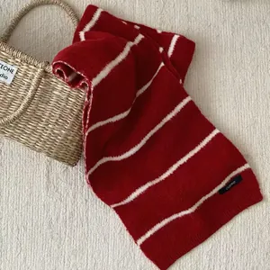 Detailed texture of a vintage red and white striped knit winter scarf for women