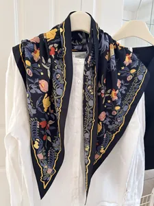 Detail of a navy floral printed triangle scarf draped over a white linen shirt