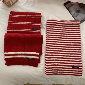 Detail view of red and white striped knit scarves with cozy texture and retro academy style.