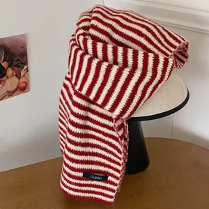 Detail view of a vintage red and white striped knit scarf showing the soft wool texture