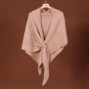 Elegant warm brown wool blend knit shawl draped on a wooden hanger