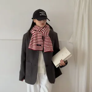 Macro view of red and white striped college style knit scarf for winter warmth